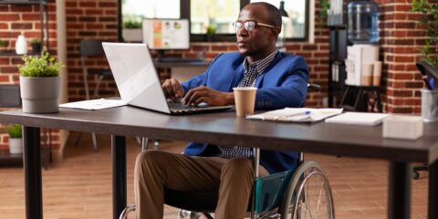 person of colour in a wheelchair working on laptop, fingolimod, novartis, patent litigation